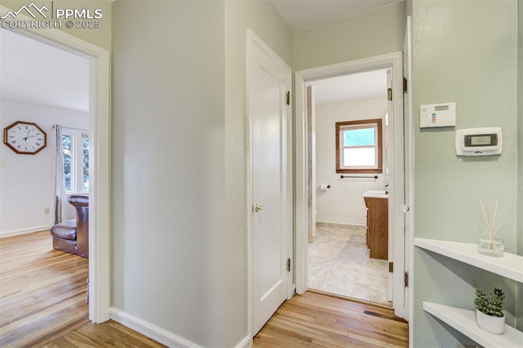 Image 25 of 48: Corridor featuring light wood-type flooring and baseboards