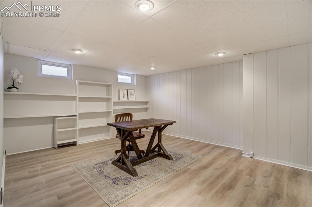 Image 31 of 48: Office space with a paneled ceiling and wood finished floors