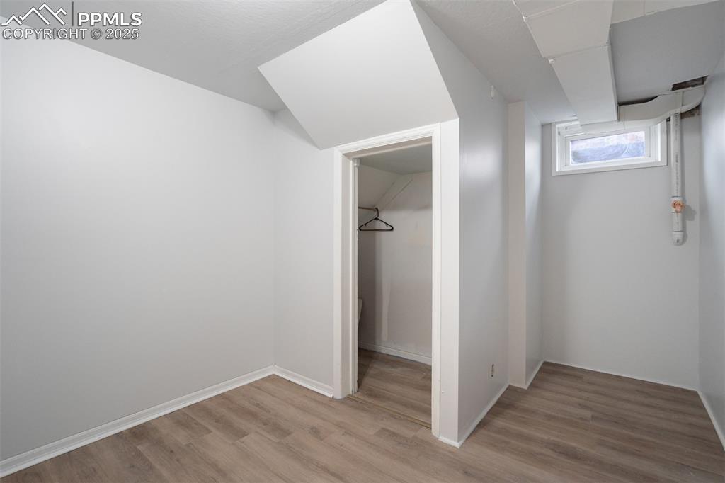 Image 35 of 48: Unfurnished bedroom with light wood-style flooring and a closet