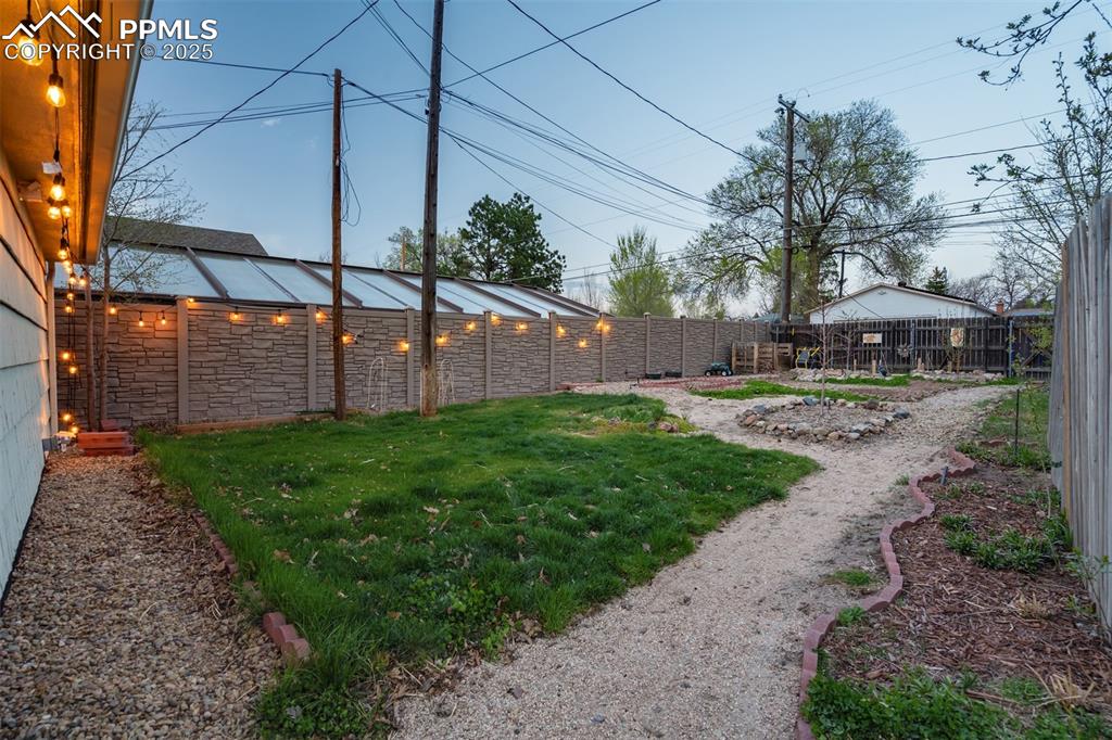 Image 40 of 48: View of fenced backyard