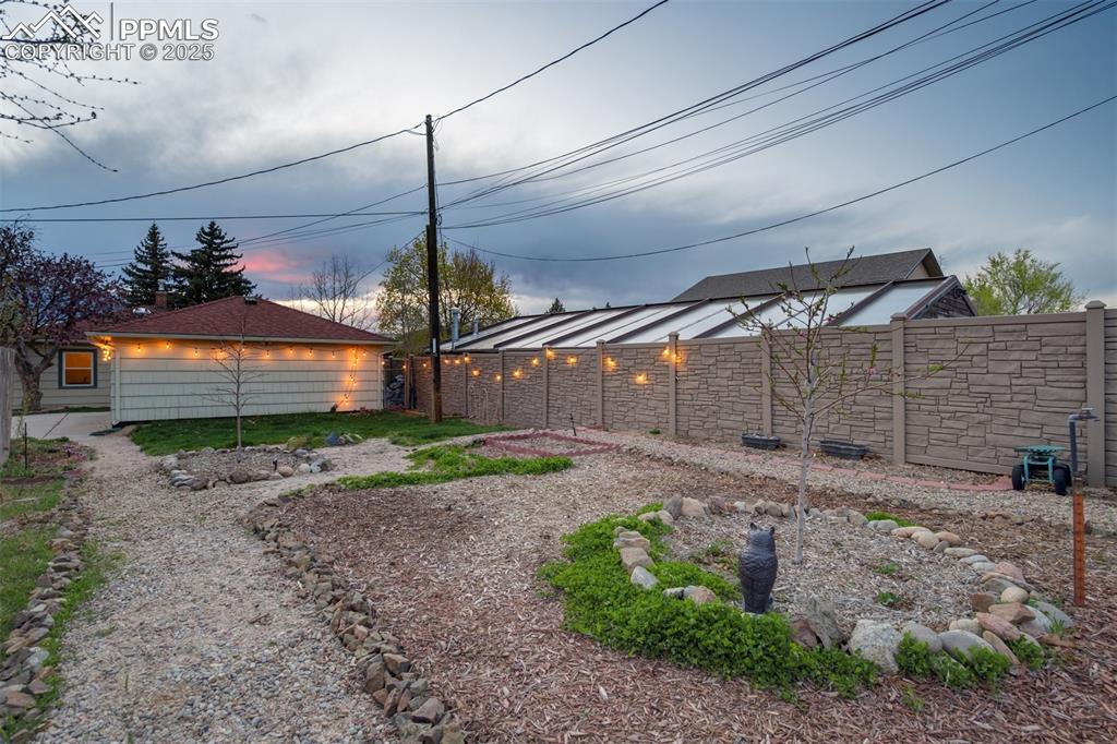 Image 41 of 48: View of yard at dusk