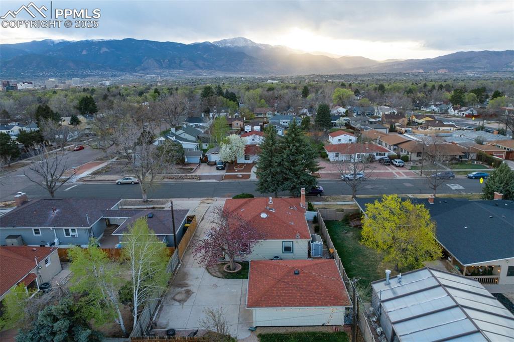 Image 47 of 48: Aerial perspective of suburban area featuring a mountainous background