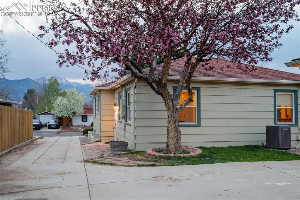 Image 6 of 48: View of side of property featuring a mountain view and a shingled roof