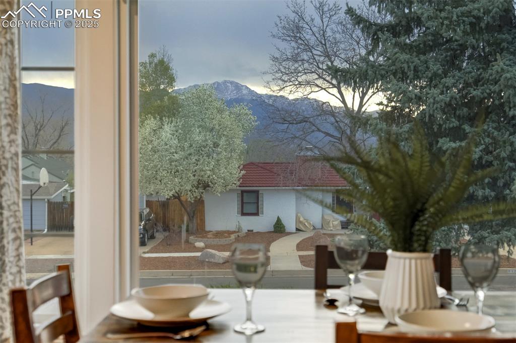 Image 7 of 48: Dining room featuring a mountain view and healthy amount of natural light