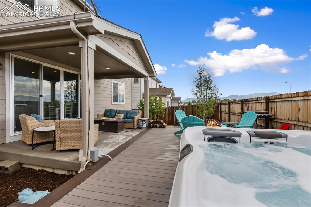 Image 6 of 48: Covered Deck and Hot Tub