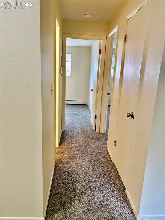 Image 8 of 27: Unit 4 hallway to bedrooms and bathroom
