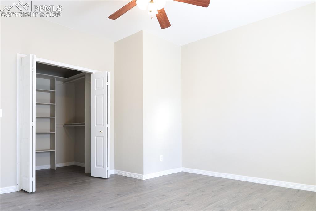 Image 35 of 49: Unfurnished bedroom with light wood-style flooring, a closet, and ceiling f