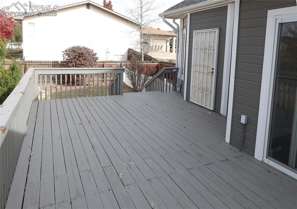Image 41 of 49: Expansive open deck connecting the walkout kitchen and master suite.