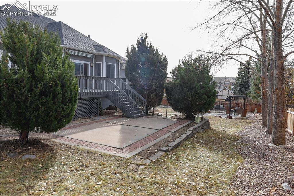 Image 42 of 49: Spacious backyard with beautiful mature trees.
