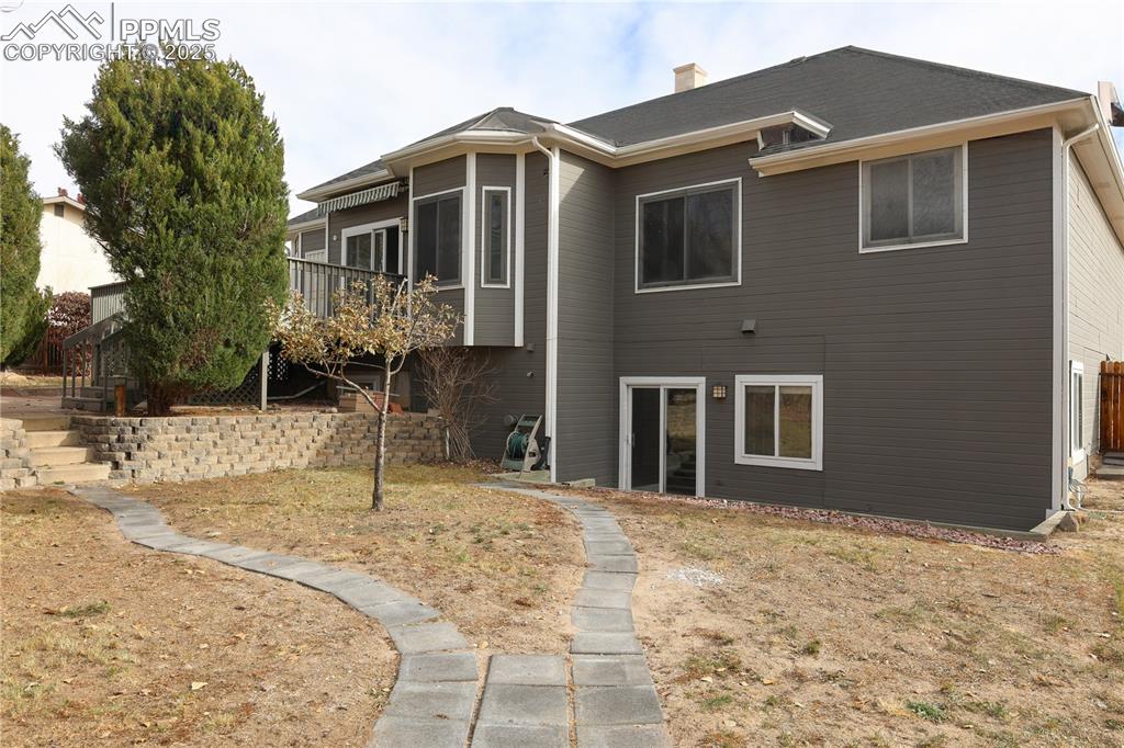 Image 49 of 49: Rear view of property with a chimney
