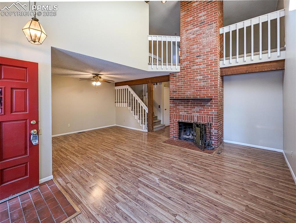 Image 2 of 27: Living Room with Gas Fireplace and open dining room