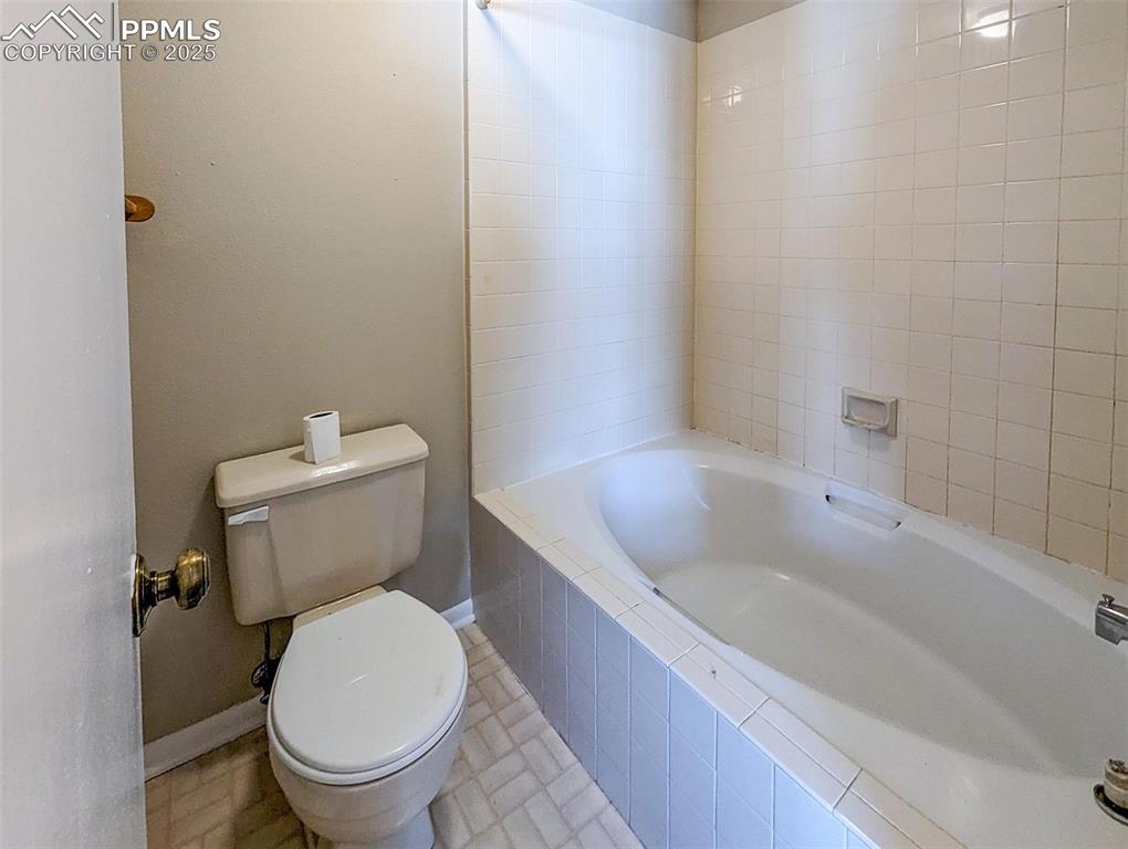 Image 22 of 27: Primary Bathroom with garden tub and separate vanity sink