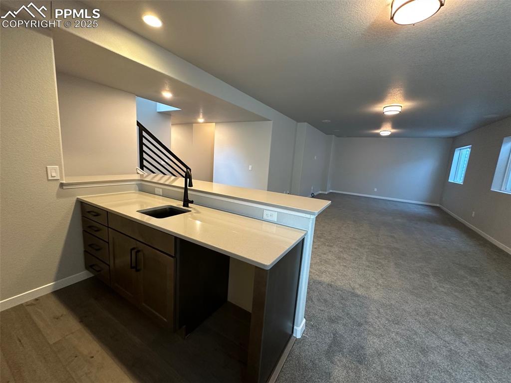 Image 12 of 20: Wet bar in basement rec room