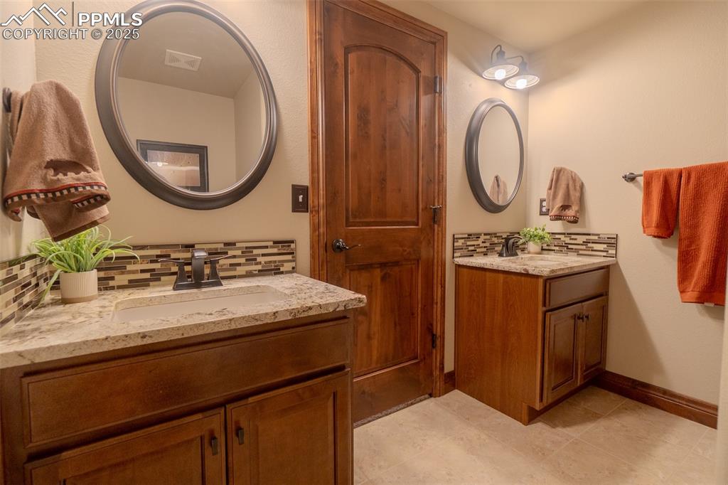 Image 40 of 50: double vanity in basement full bathroom
