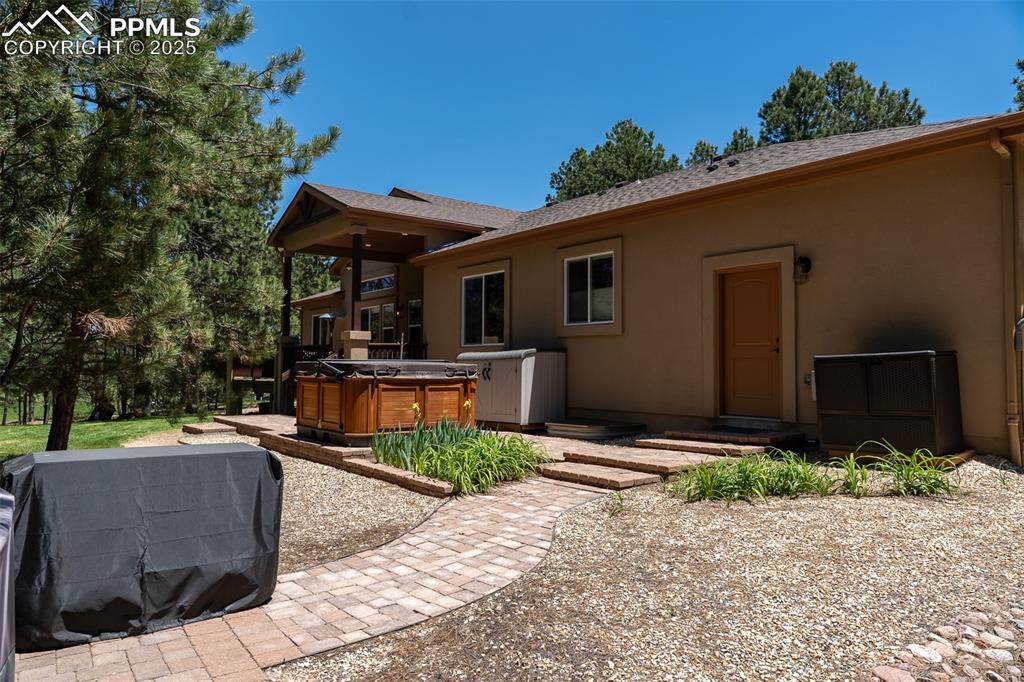 Image 46 of 50: back of home with access to garage