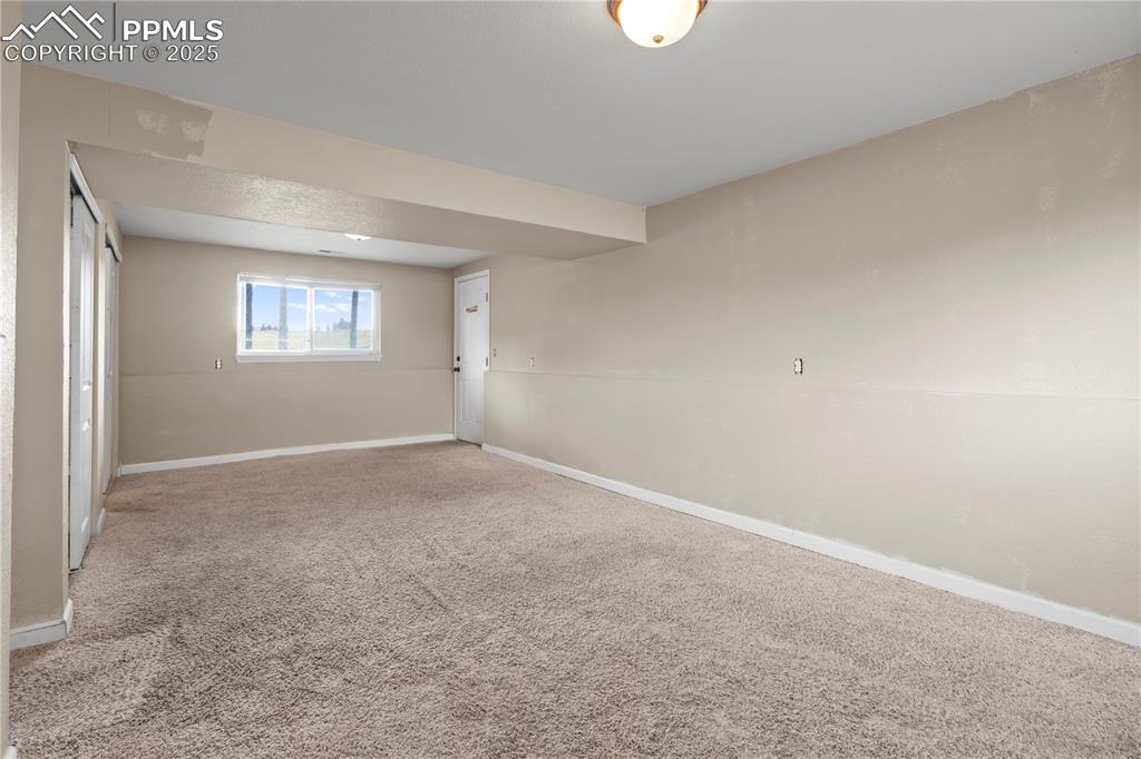 Image 14 of 34: Unfurnished room with carpet floors and baseboards