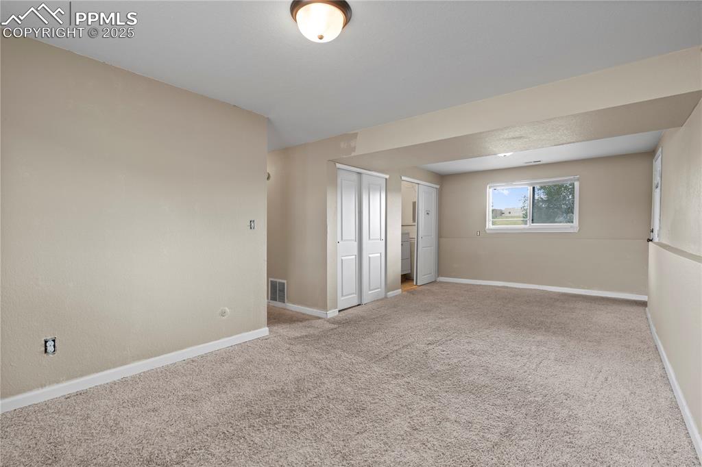 Image 15 of 34: Empty room with carpet flooring and baseboards