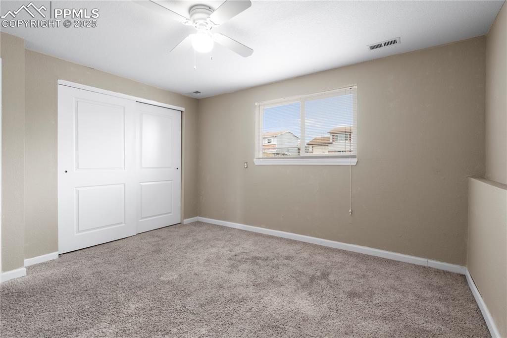 Image 19 of 34: Unfurnished bedroom featuring light colored carpet, a closet, and ceiling f
