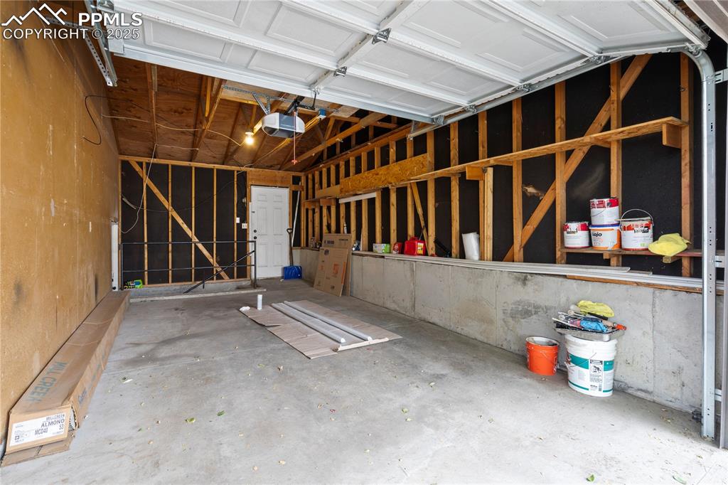 Image 20 of 34: Garage featuring a garage door opener