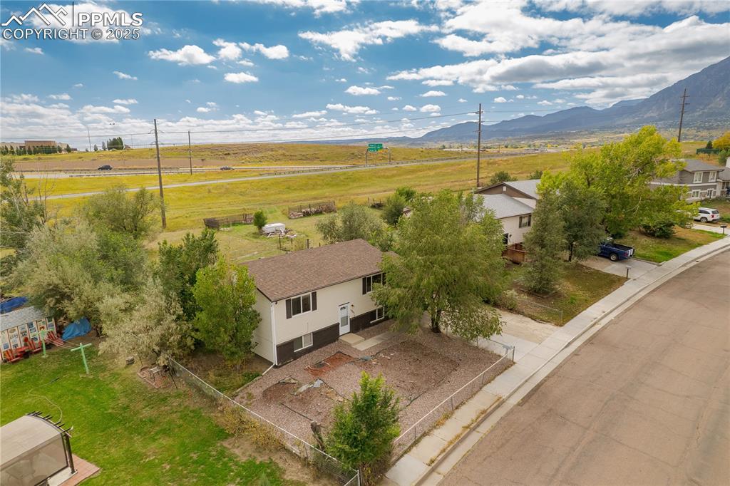 Image 26 of 34: Aerial view of sparsely populated area with mountains