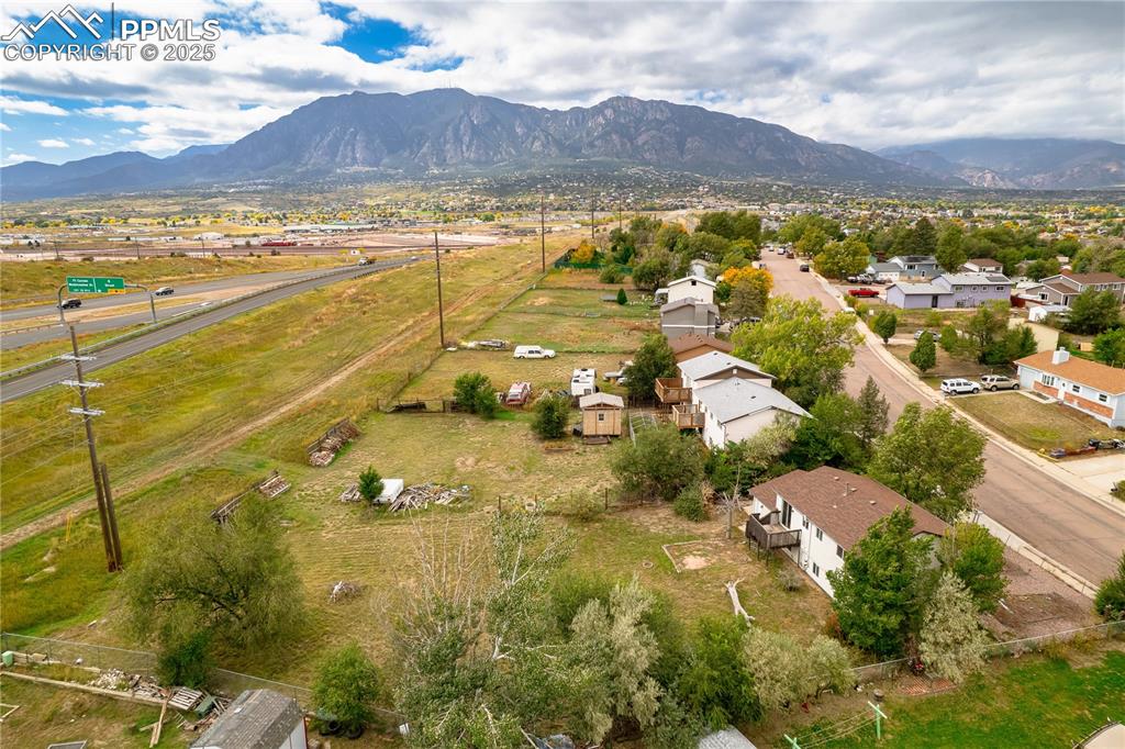 Image 28 of 34: Aerial perspective of suburban area with a mountain backdrop
