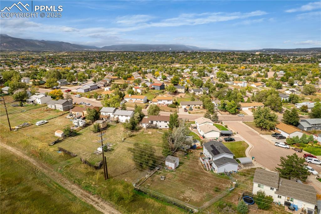 Image 32 of 34: Aerial perspective of suburban area featuring a mountain backdrop