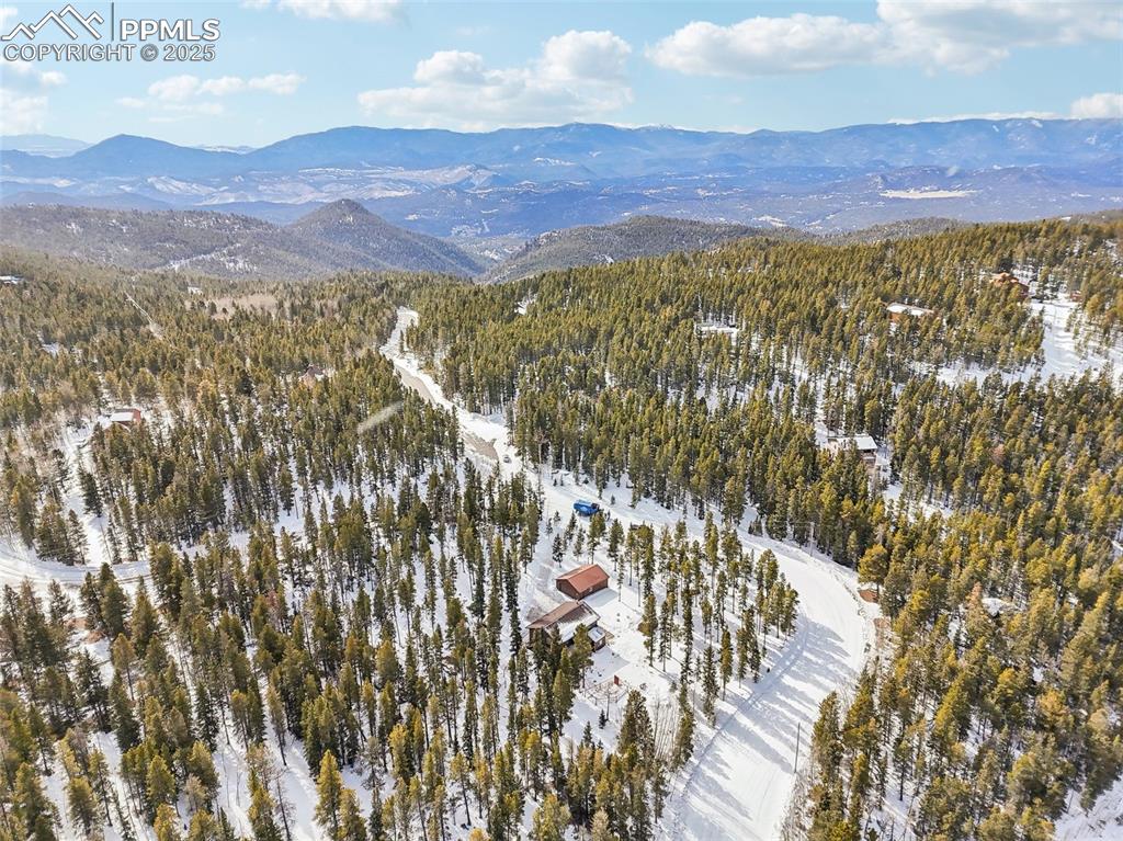 Image 12 of 50: Snowy aerial view with a mountain view