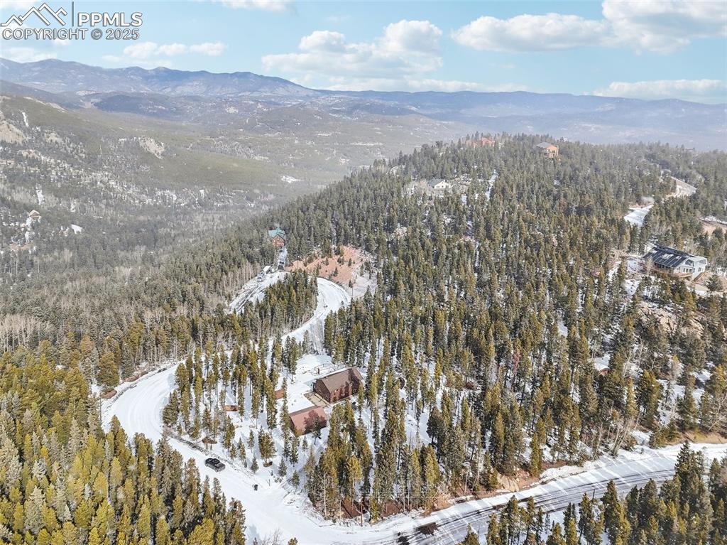 Image 49 of 50: Snowy aerial view with a mountain view