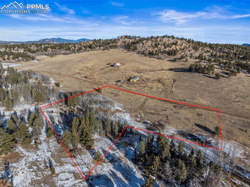 Image 13 of 25: Overview of rural landscape with property parcel outlined and mountains. Pr