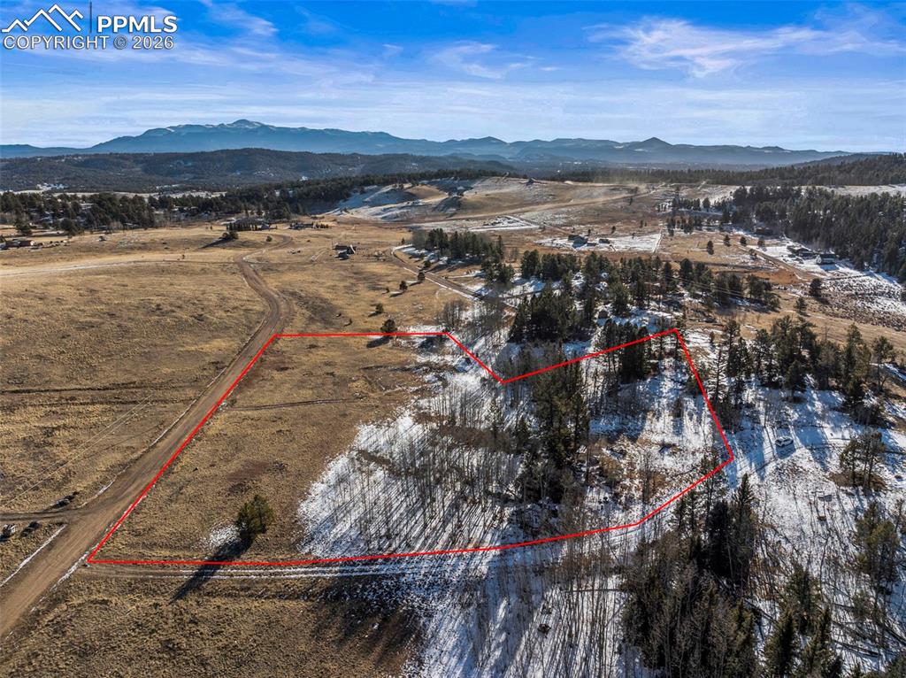 Image 7 of 25: Overview of rural landscape with property parcel outlined and mountains. Pr