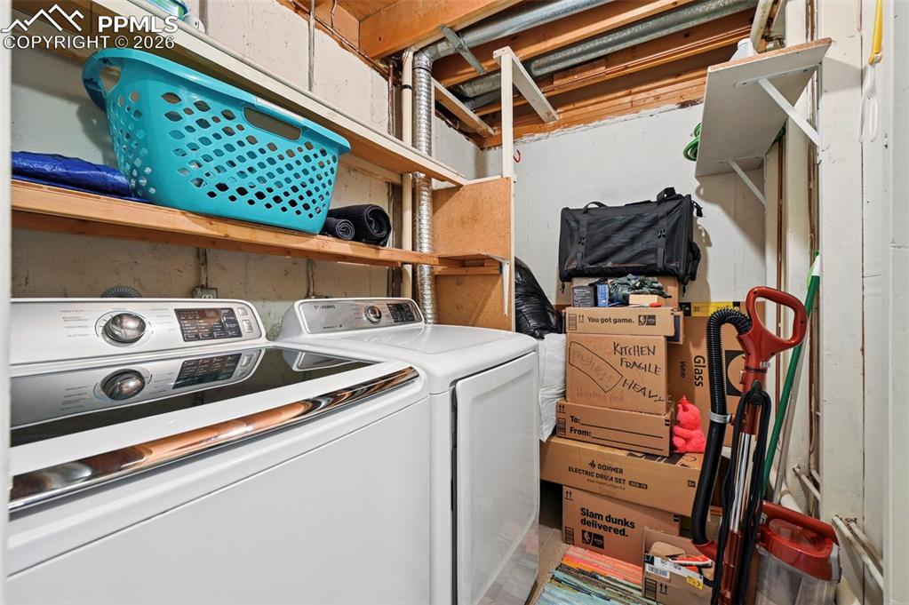 Image 24 of 31: Laundry room in basement. Washer and Dryer stay