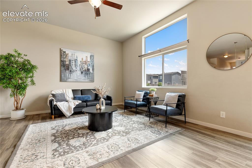 Image 5 of 29: Spacious living room with ceiling fan and easy maintenance luxury vinyl flo