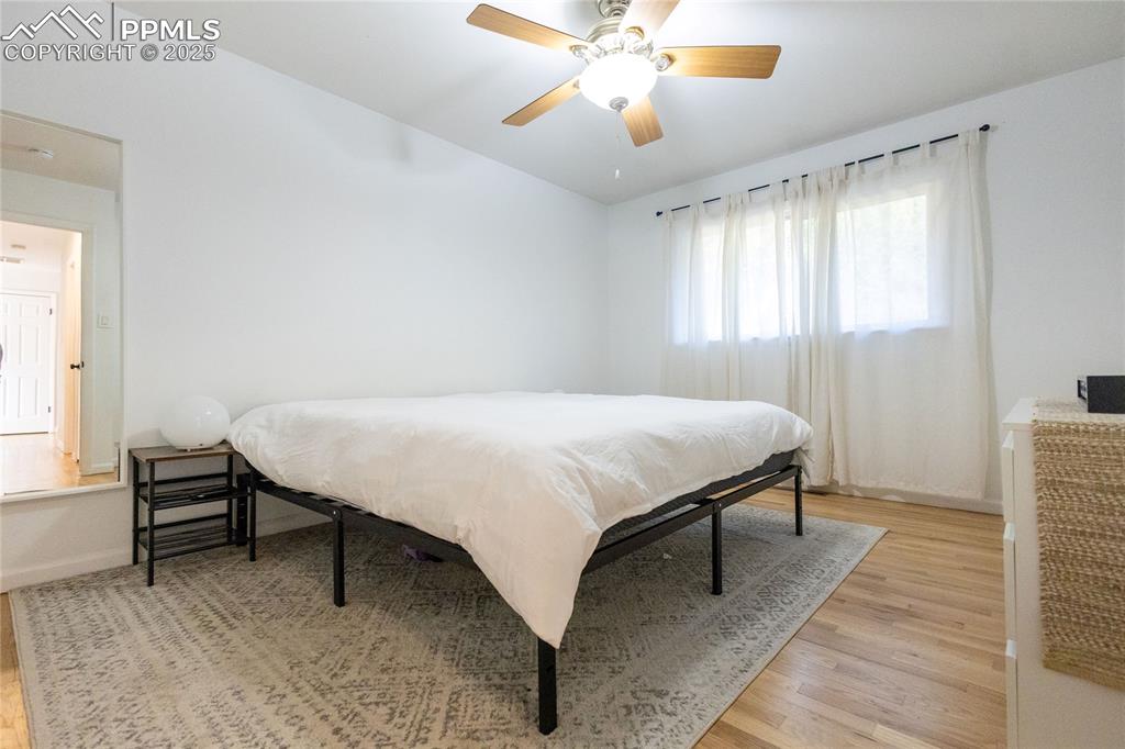 Image 10 of 27: Bedroom featuring ceiling fan and light wood-style floors