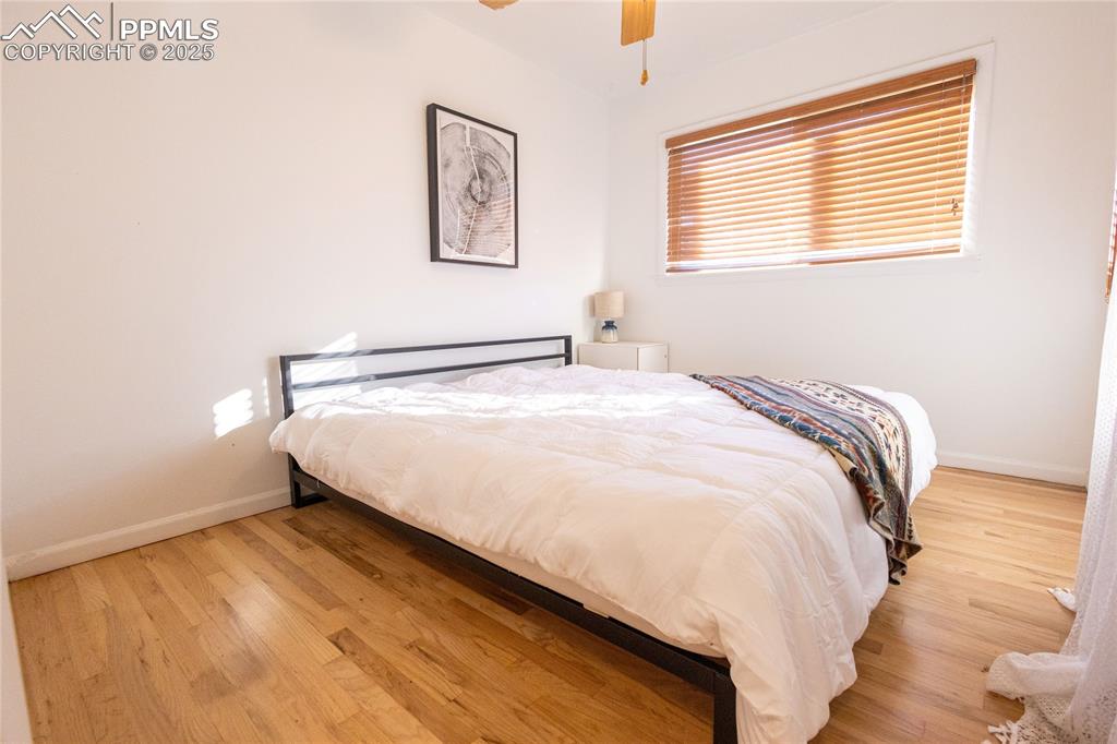 Image 12 of 27: Bedroom featuring light wood-type flooring and ceiling fan