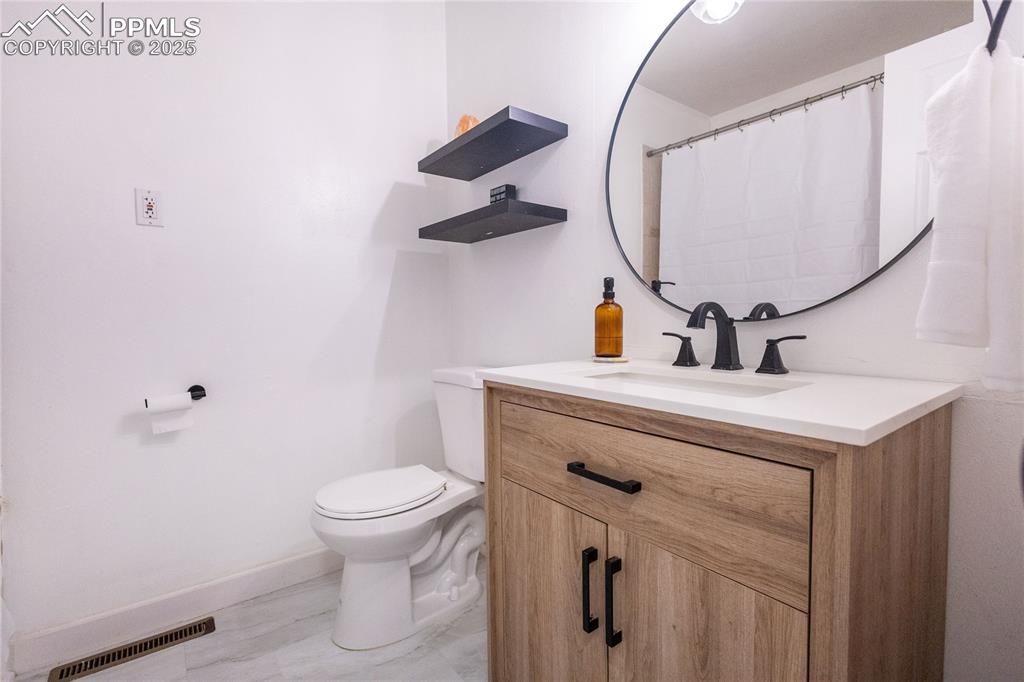 Image 14 of 27: Bathroom with vanity and a shower with curtain