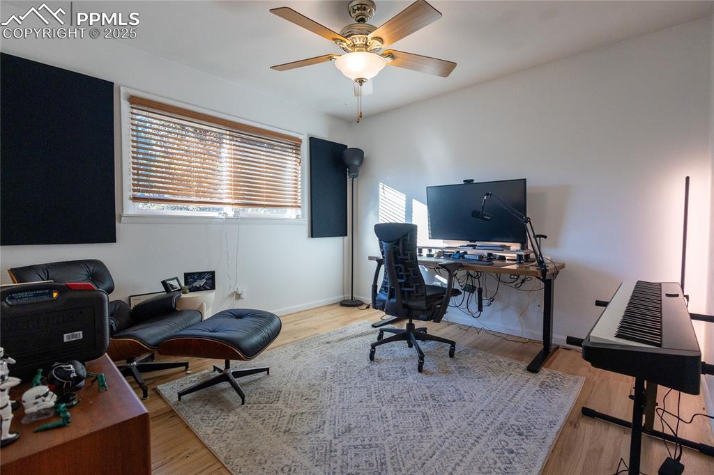 Image 15 of 27: Home office with light wood finished floors and ceiling fan