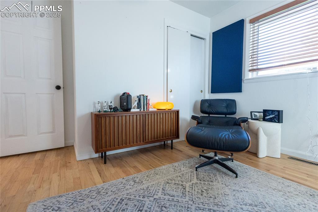 Image 16 of 27: Sitting room with baseboards and light wood-style floors