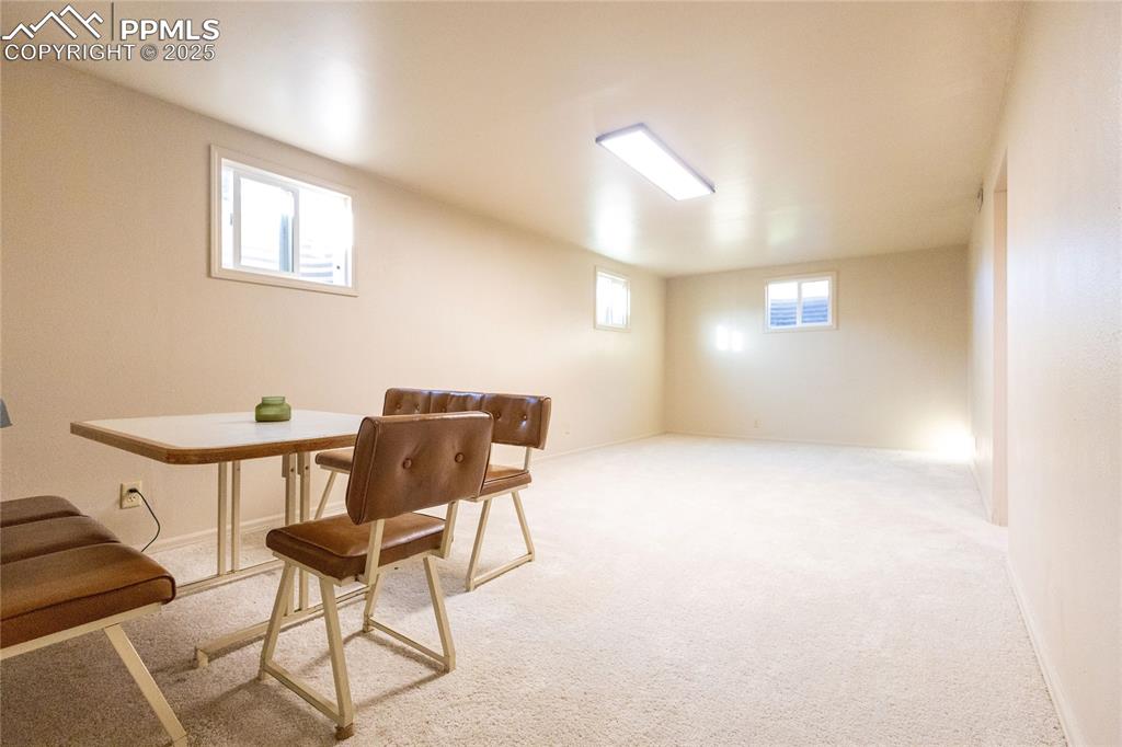 Image 19 of 27: Dining room with light colored carpet and baseboards