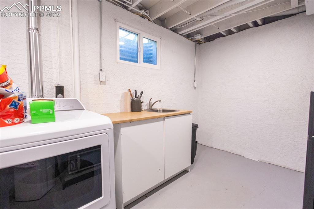 Image 21 of 27: Laundry room with washer / dryer and a textured wall