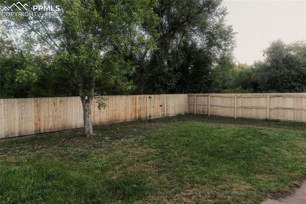 Image 23 of 27: View of fenced backyard