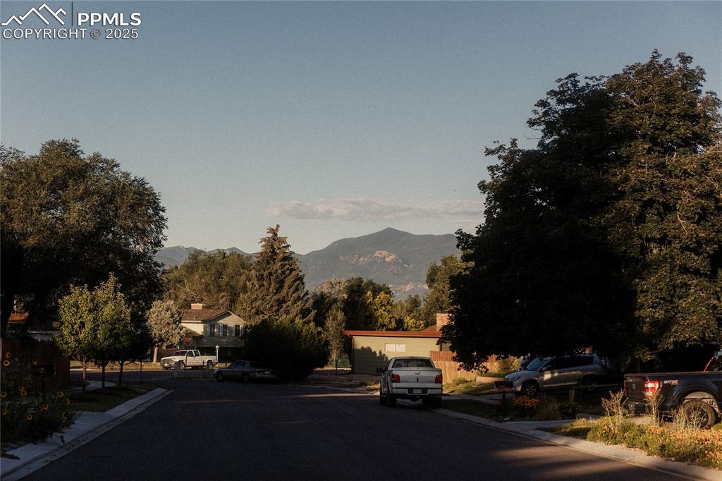 Image 26 of 27: View of asphalt road with curbs and a mountain view