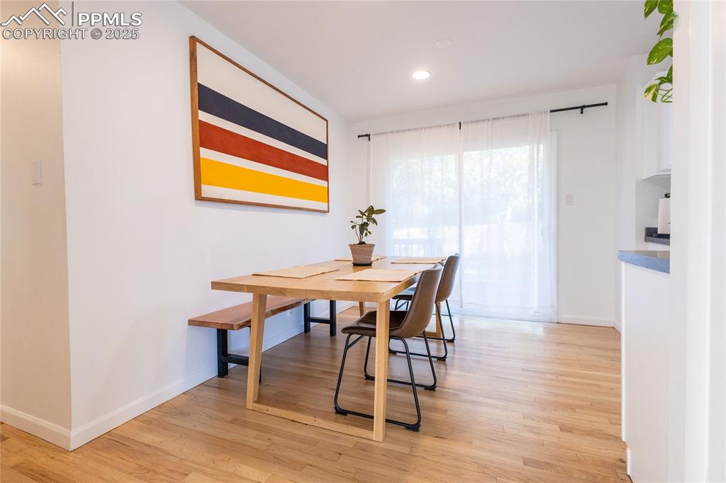 Image 9 of 27: Dining area with light wood-type flooring and recessed lighting