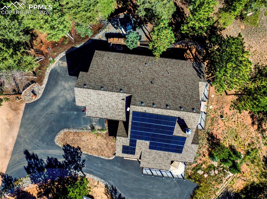 Image 26 of 31: Outside you can see the fully paved driveway, and those coveted solar panel