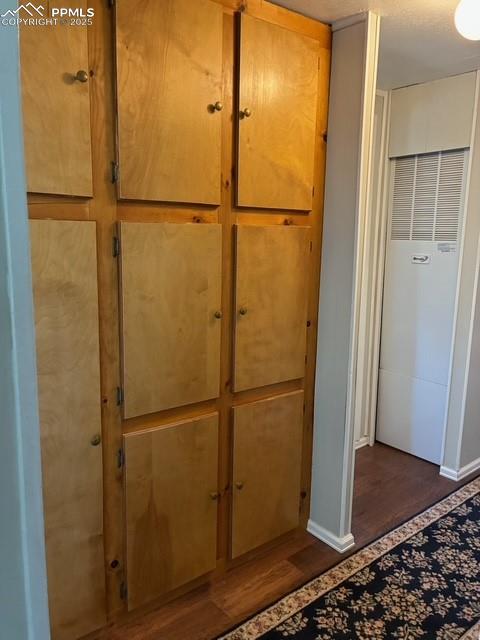 Image 19 of 30: Detailed view of wood finished floors and a heating unit