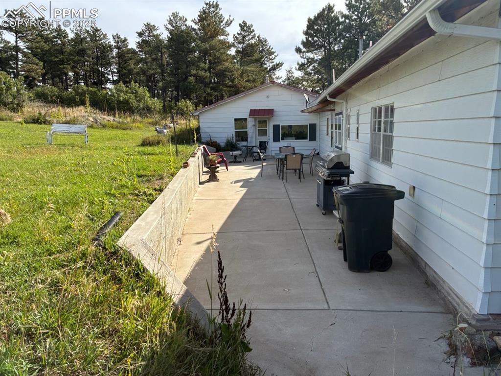 Image 24 of 30: View of patio / terrace with area for grilling and outdoor dining space