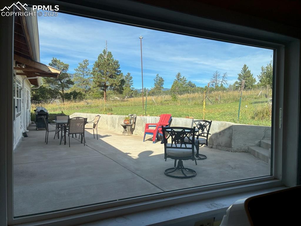 Image 30 of 30: View of patio featuring outdoor dining space and a grill