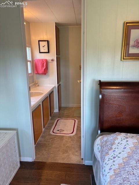 Image 9 of 30: Bathroom featuring dark wood finished floors and vanity