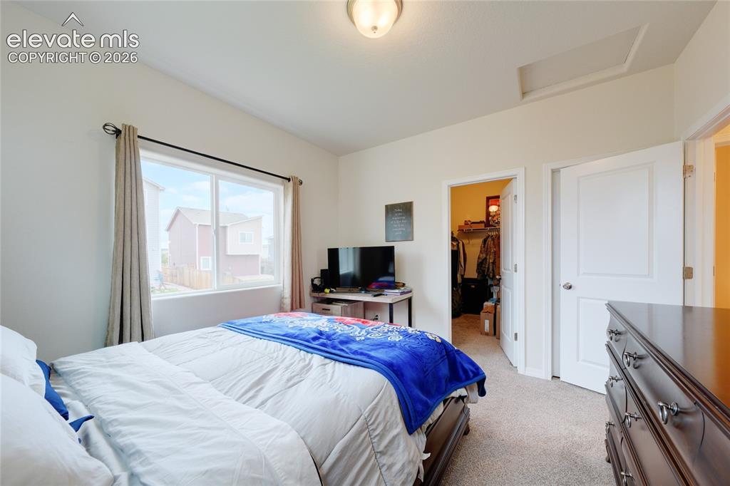 Image 19 of 21: Bedroom featuring neutral carpeting, a large window, a walk-in closet, and 