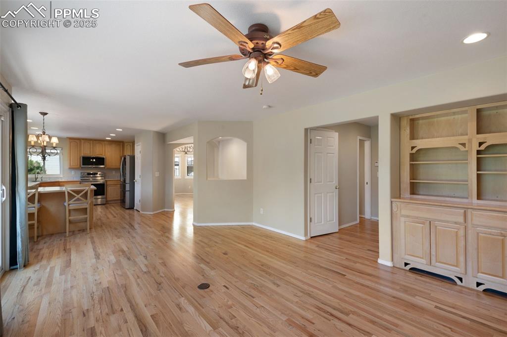 Image 15 of 37: Unfurnished living room featuring recessed lighting, a chandelier, light wo