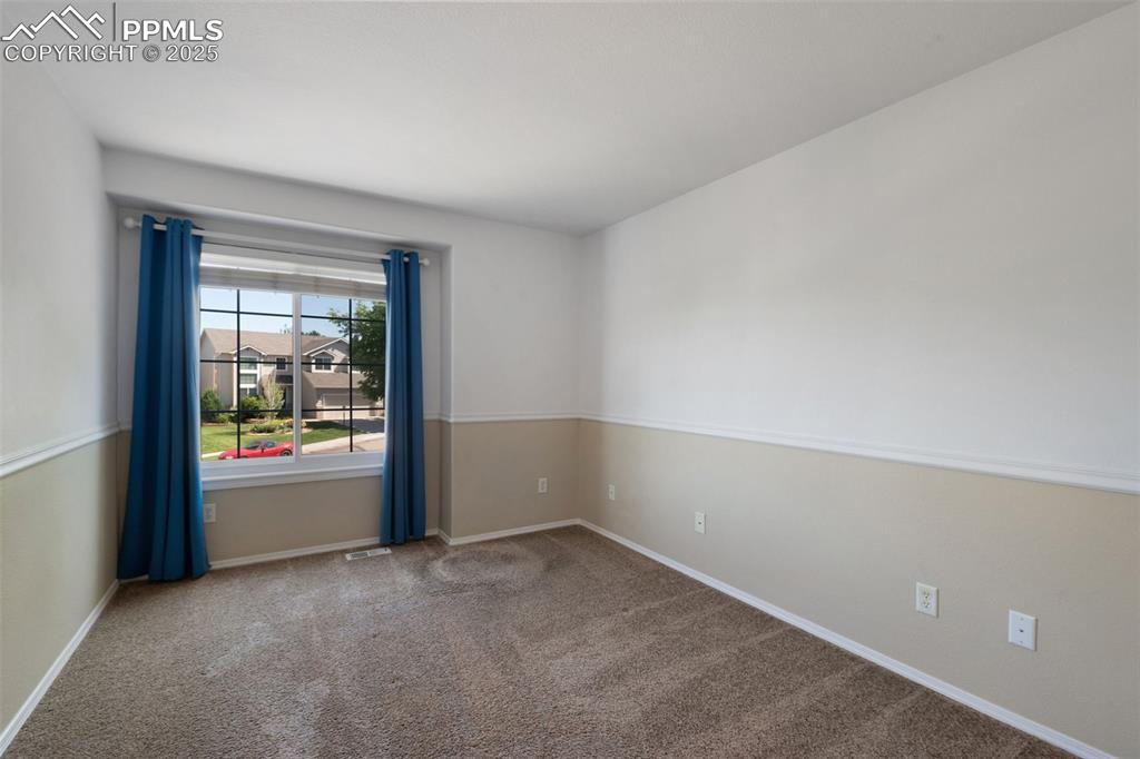 Image 24 of 37: Spare room featuring carpet and baseboards